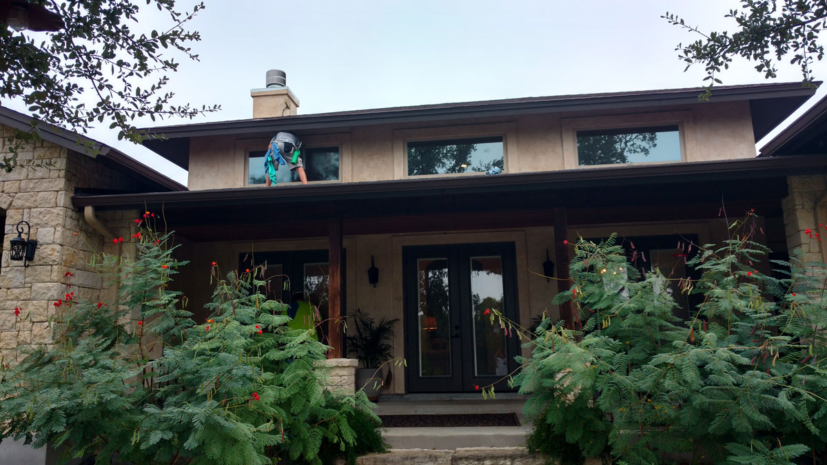 Window cleaning a two story home.